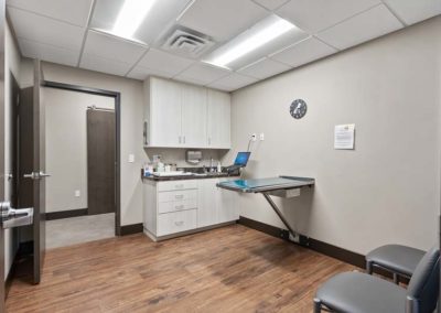 A veterinary office with a desk and chairs.